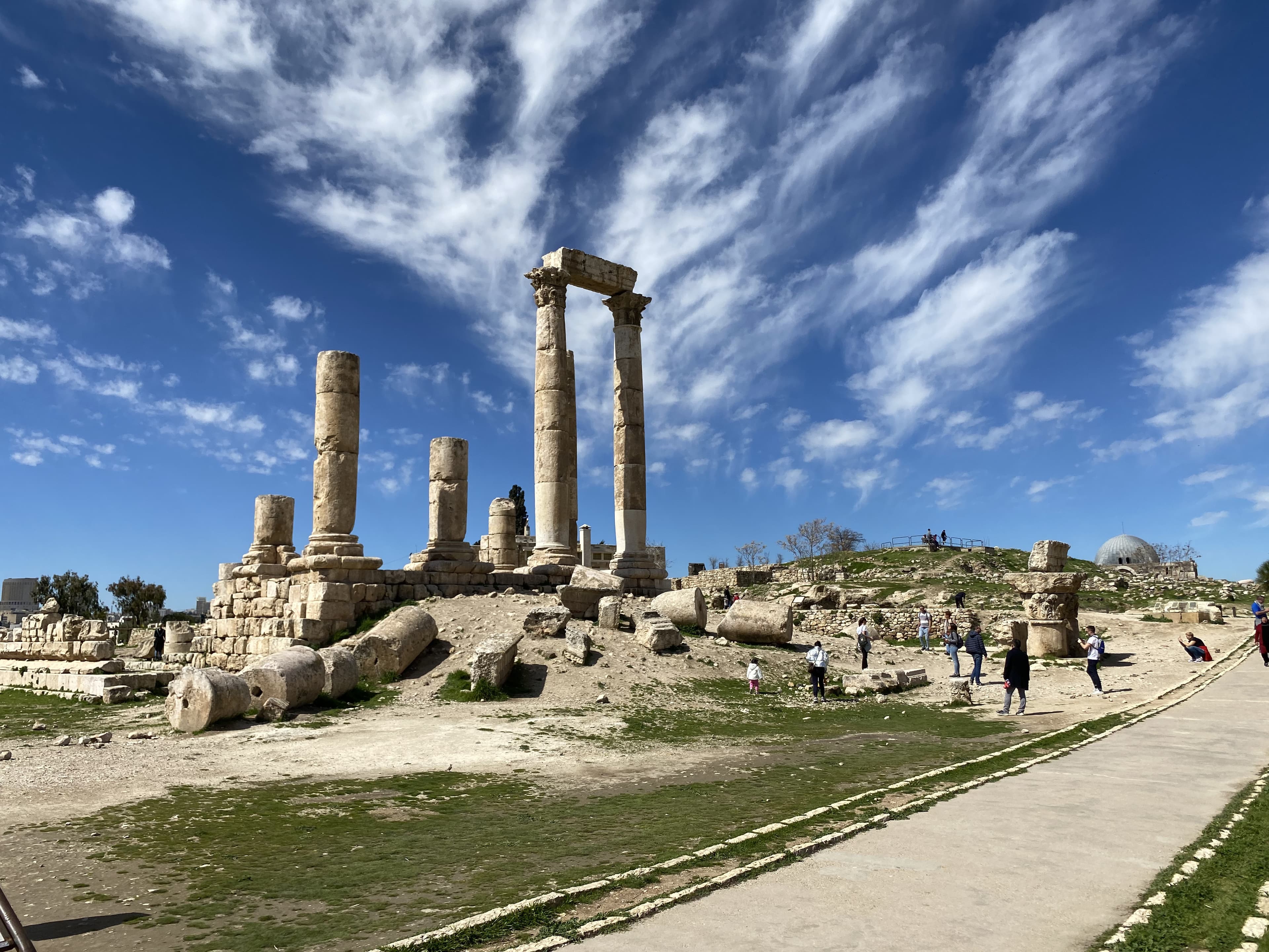 Ancient stone columns and ruins beneath a blue sky