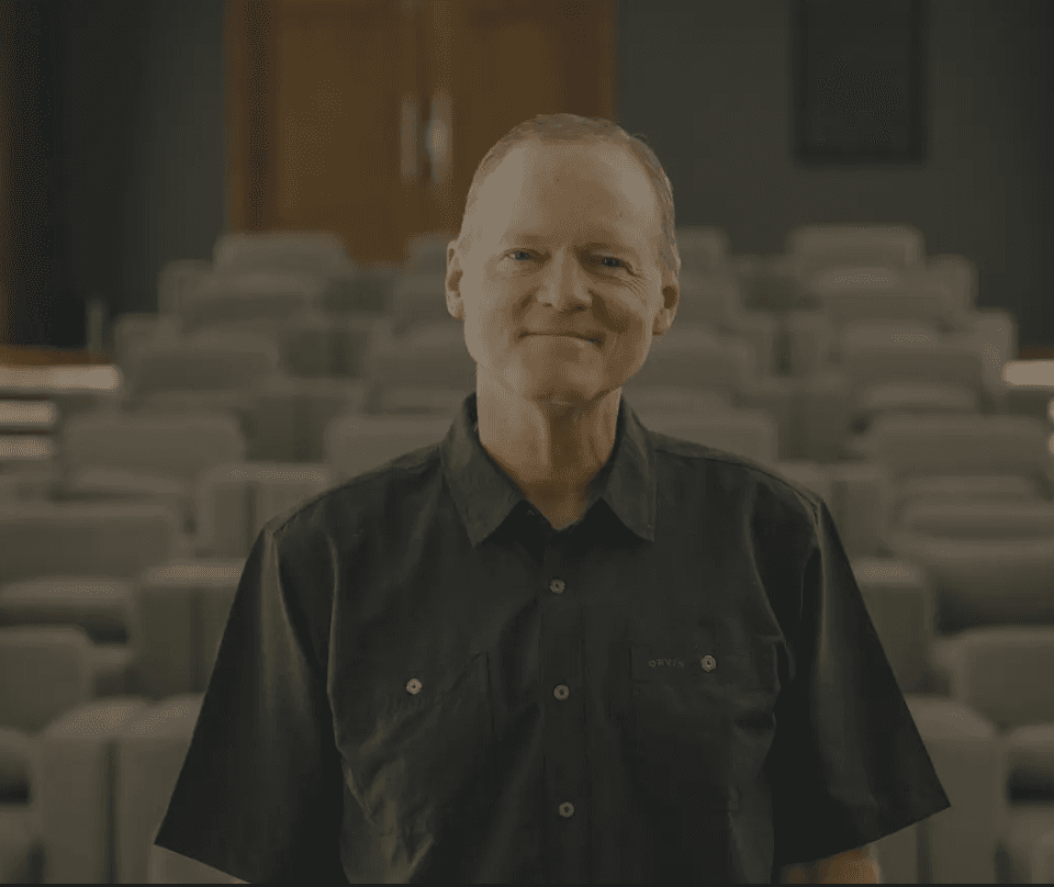 Dr. Gary G. Hoag standing in an auditorium